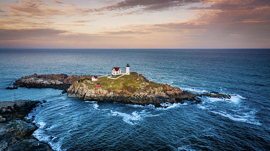 Nubble lighthouse at sunset Photograph by Alexey Stiop