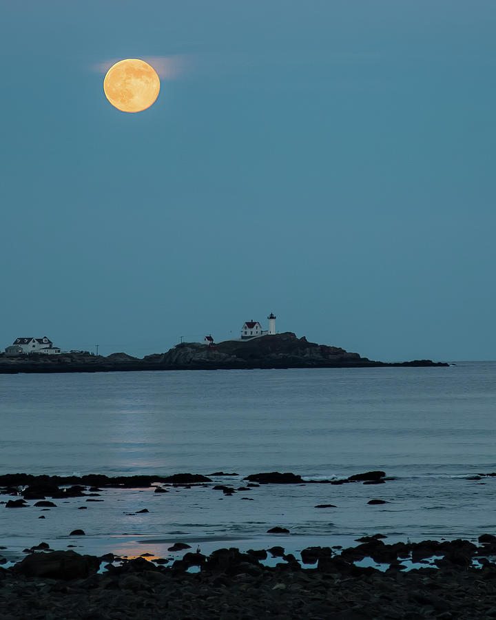 Nubble lighthouse under full moon Photograph by Jeff Folger