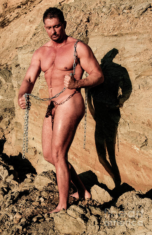 Nude male bodybuilder breaking chains  Photograph by Gunther Allen
