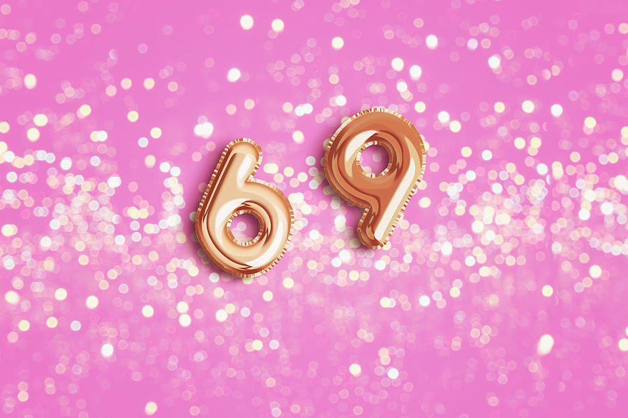 number 69 in foil ballon.Pink background Photograph by Carol Yepes