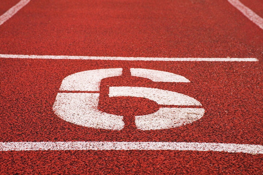 Number six. White athletic track number on red rubber racetrack Photograph by Rdonar