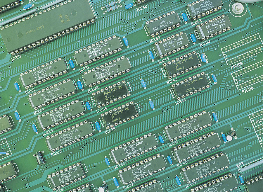 Numerous micro-chips on a circuit board Photograph by Chris Knapton