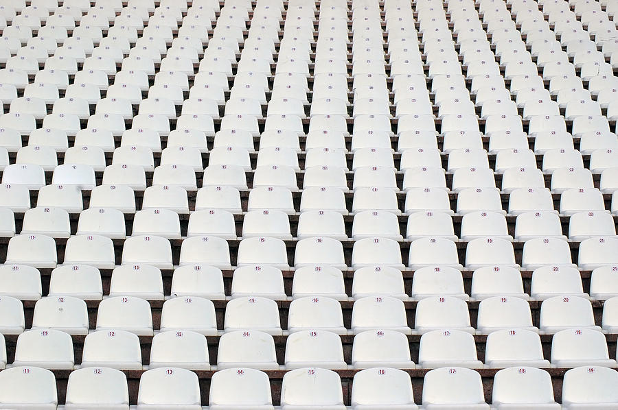 Numerous rows of white stadium seats Photograph by Gizmo