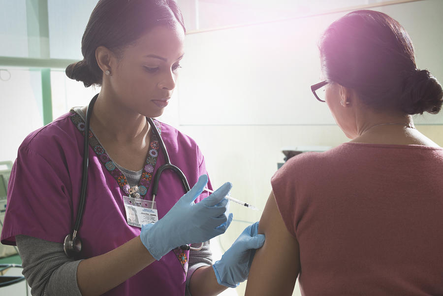Nurse giving patient injection in hospital Photograph by Jose Luis Pelaez Inc