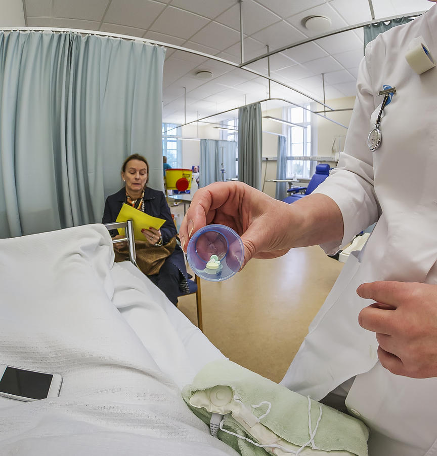 Nurse giving patient meds for cancer therapy Photograph by Arctic-Images