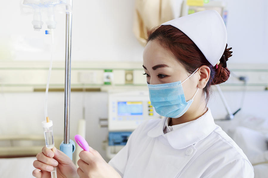 Nurse preparing intravenous drip Photograph by Owngarden