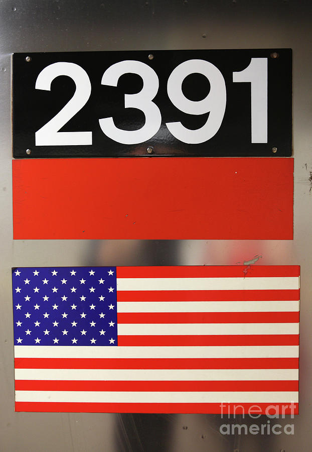 NYC subway car number and flag Photograph by Bryan Attewell