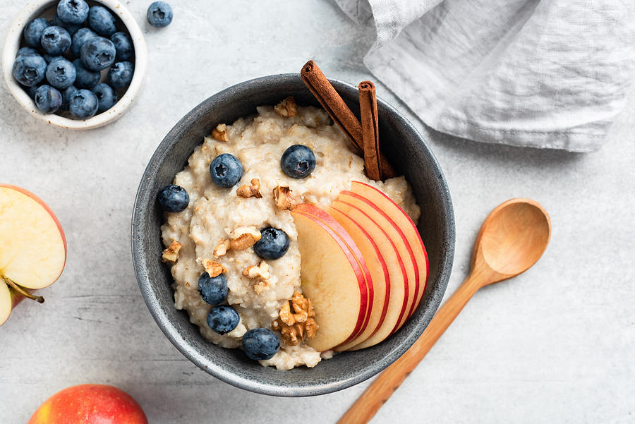 Oatmeal porridge with apple, cinnamon and blueberries Photograph by Arx0nt