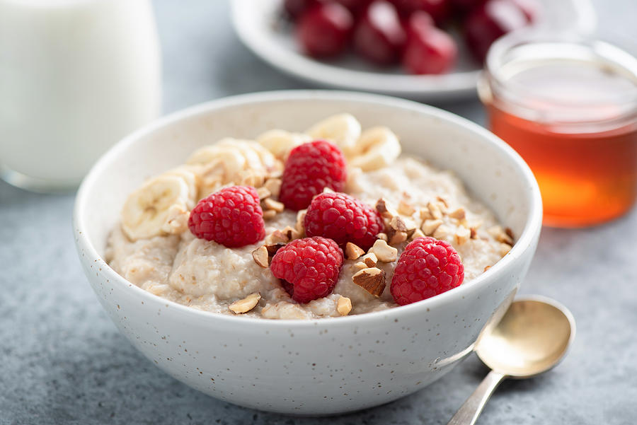 Oatmeal porridge with raspberries and nuts Photograph by Arx0nt