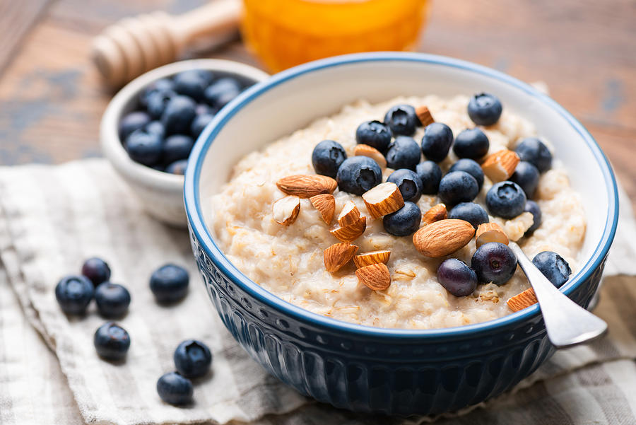 Oatmeal with blueberries and almonds Photograph by Arx0nt