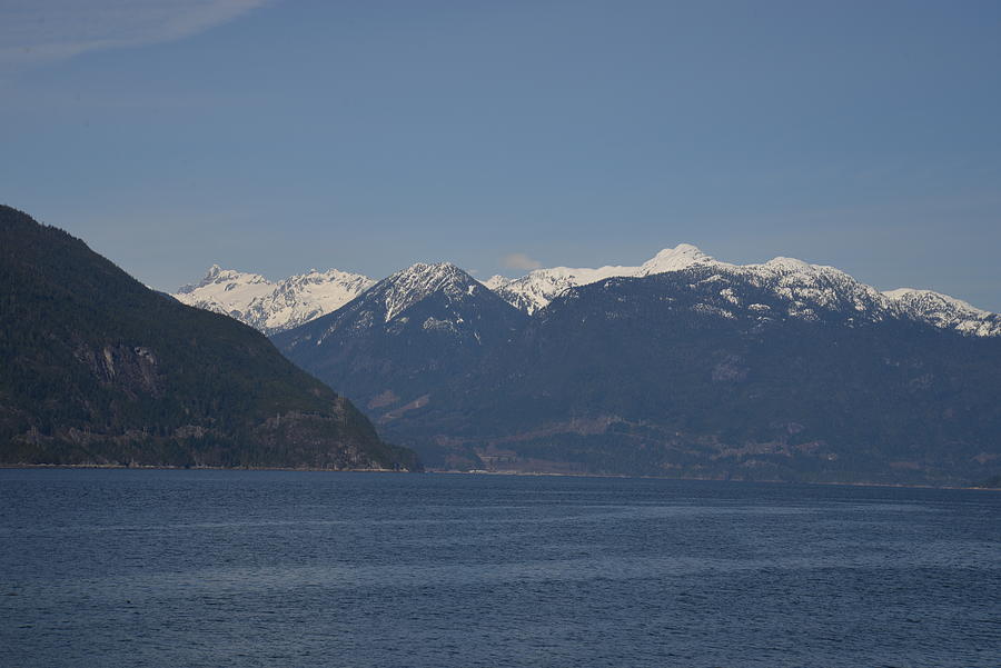 Ocean leading to Snow Capped Mountains Photograph by James Cousineau