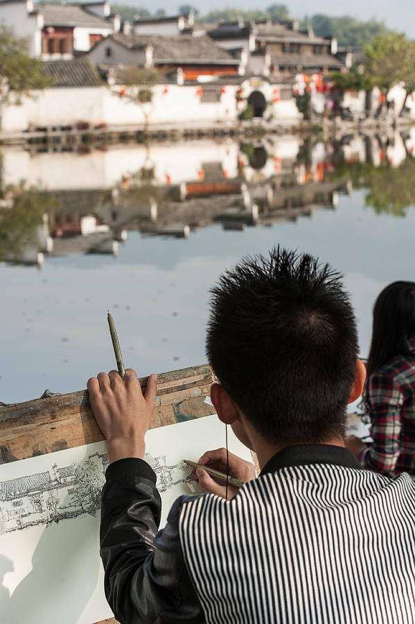 October 18, 2014. Hongcun Village, China. Local students sketching the scenery near an ancient picturesque village that has long enjoyed the name a village in the Chinese painting Photograph by Oleksandra Korobova