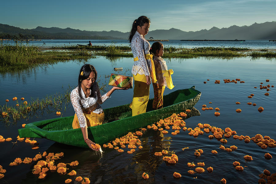 Offerings on lake Batur by young Balinese girls in the early morning Photograph by Anges Van der Logt