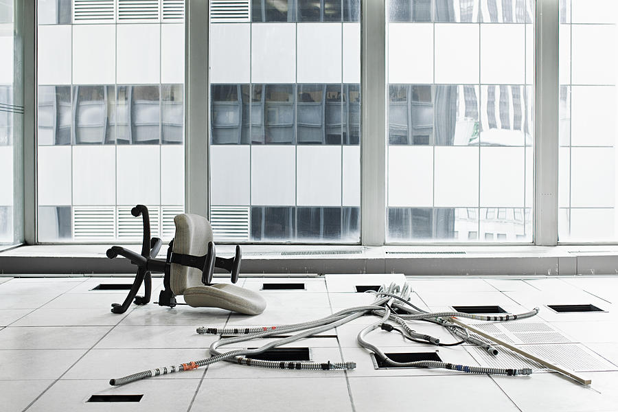 Office chair and cables on floor Photograph by Image Source