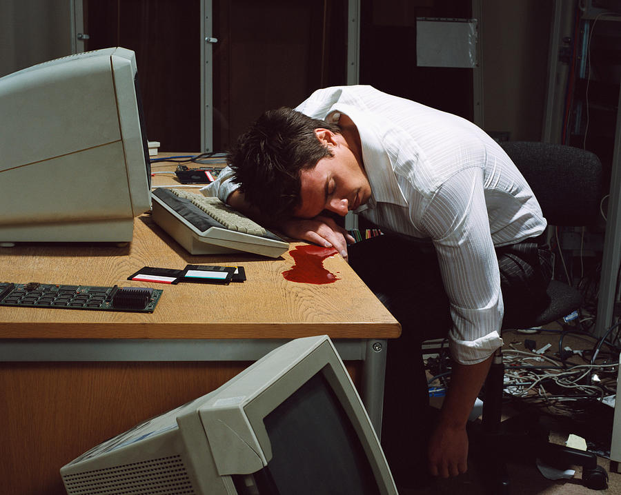 Office worker dead at his desk Photograph by Image Source