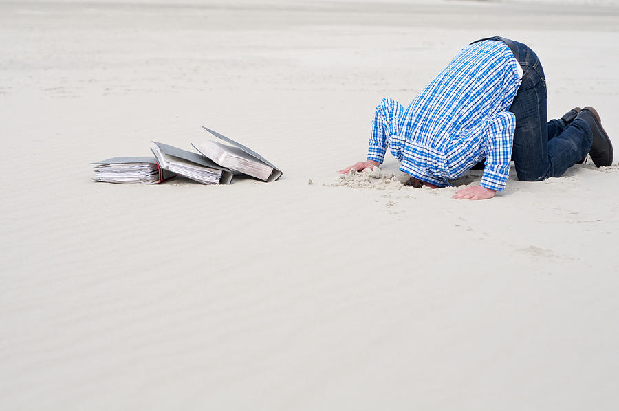 Office Worker Hiding Head In Sand Photograph by Marvinh