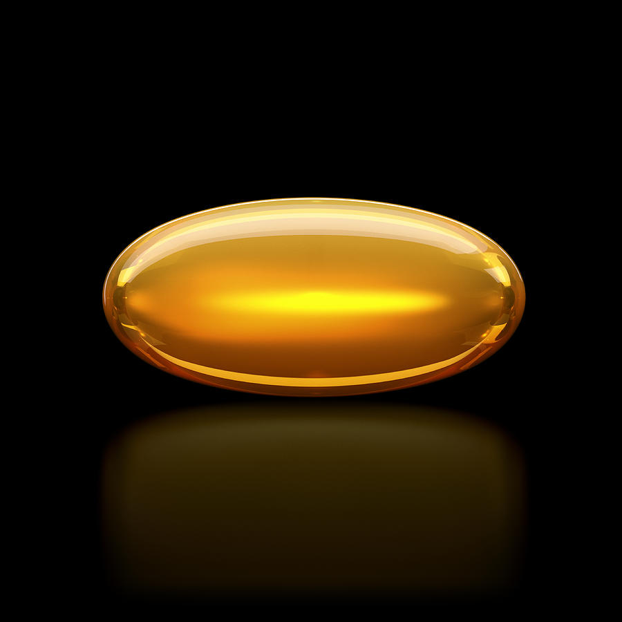Oil / medication pill capsule on black surface Photograph by I Like That One
