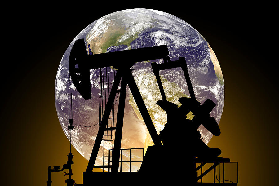 Oil pump on a planet Earth background. Concept of World Oil Industry Photograph by Anton Petrus