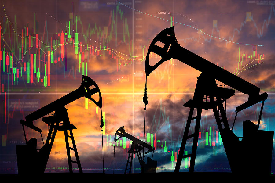 Oil pump with candle stick graph chart in the background. World Oil Industry Photograph by Anton Petrus