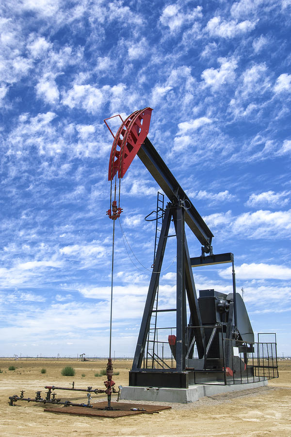 Oil Pumpjack with Clouds in Background Photograph by GomezDavid