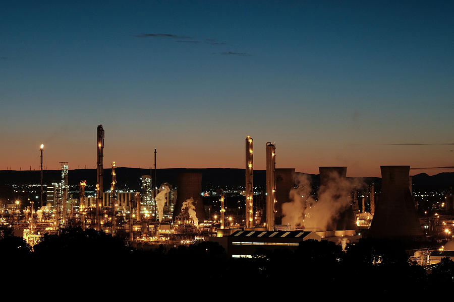 Oil refinery at dusk Photograph by Bob Last