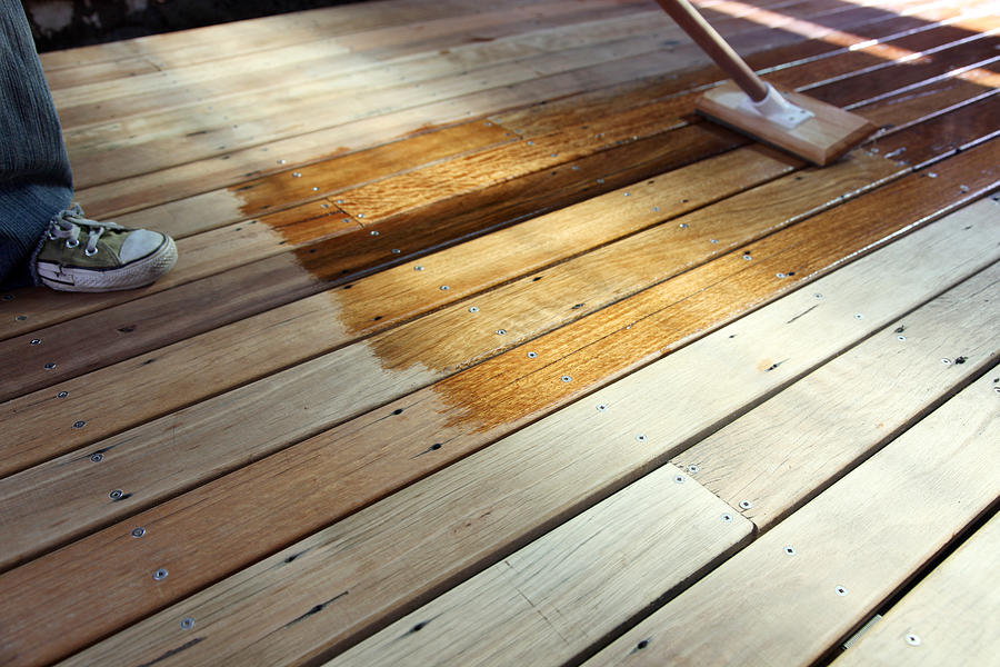 Oiling the deck Photograph by LisaInGlasses