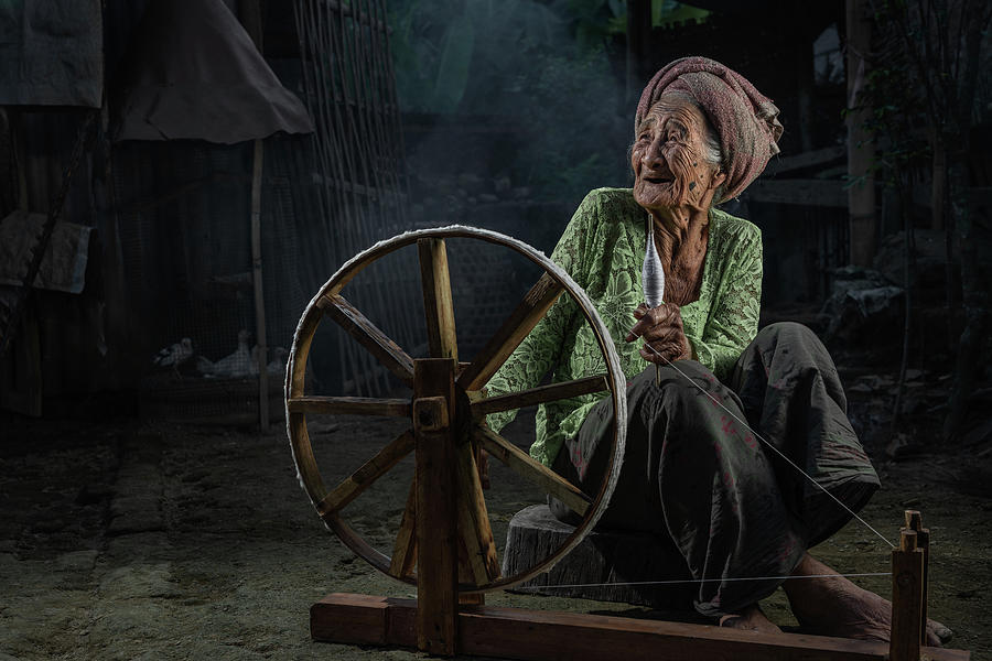 Old Balinese lady with her spinning wheel Photograph by Anges Van der Logt
