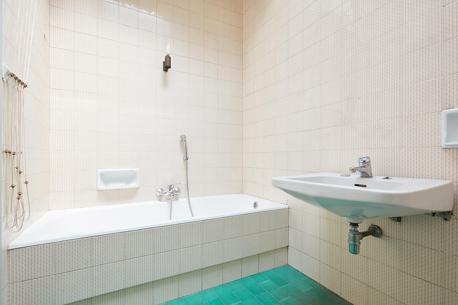 Old bathroom, tiled interior with bathtub Photograph by AndreaAstes