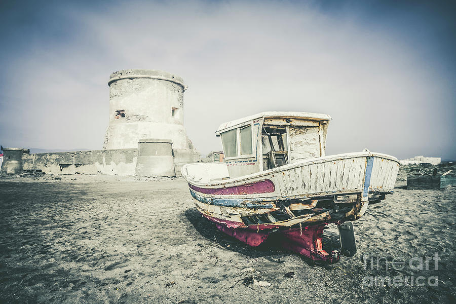 Old boat in front of 16th century San Miguel Tower on the beach of Cabo de gata, Almeria, Spain Photograph by Perry Van Munster