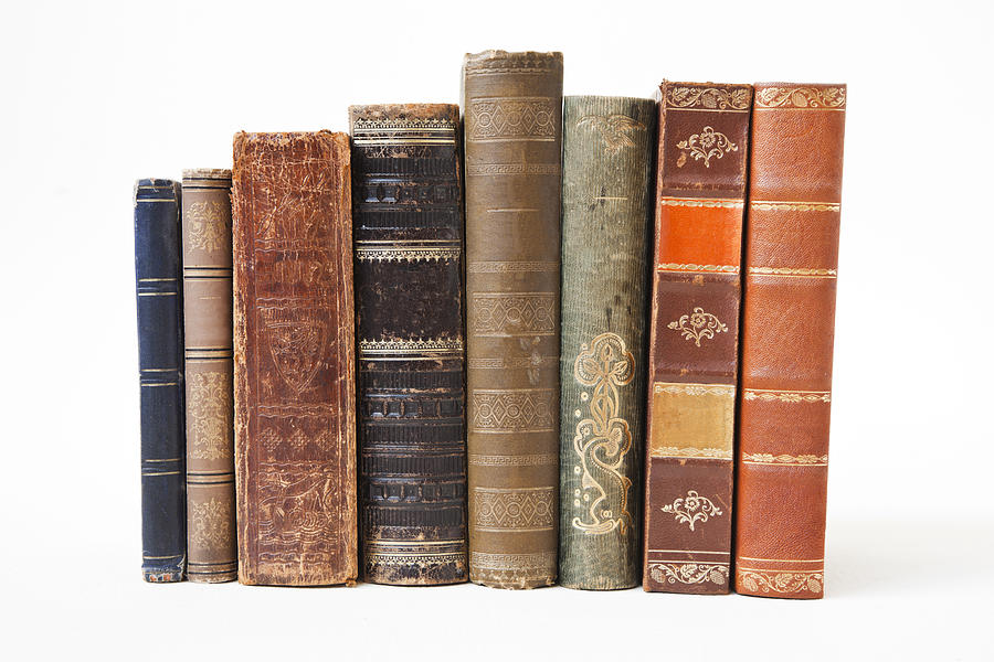 Old books on white background. Photograph by Ekely