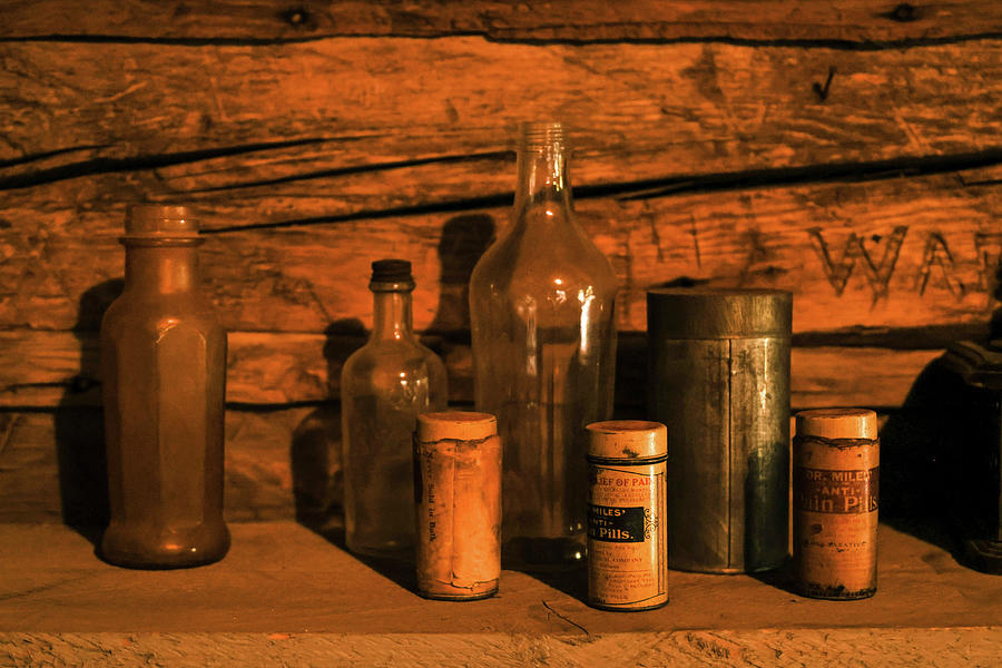 Old bottles on an old shelf  Photograph by Jeff Swan