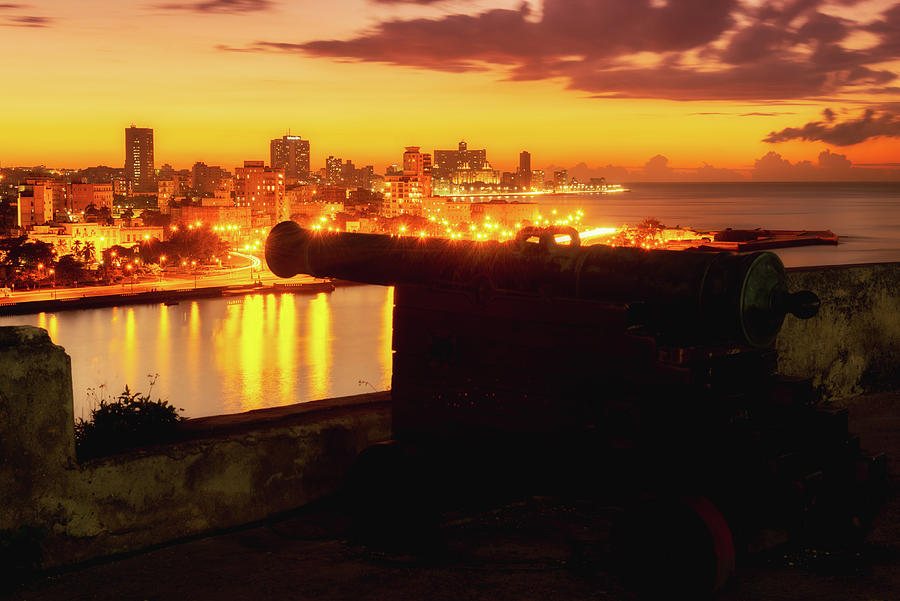 Old cannon and the city of Havana at sunset Photograph by Karel Miragaya