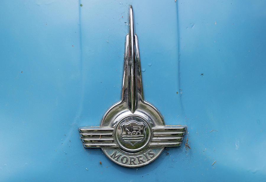 Old chrome Morris badge on blue car Photograph by Steven Heap