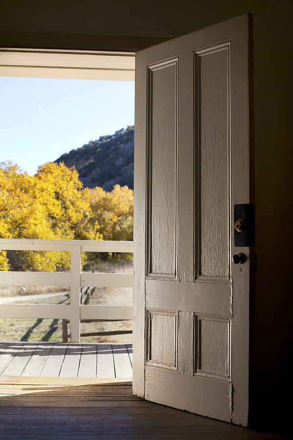 Old door looking out to fall foliage Photograph by Jason Todd
