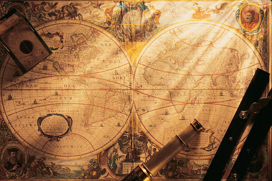 Old-fashion world map with navigational tools on top Photograph by Comstock