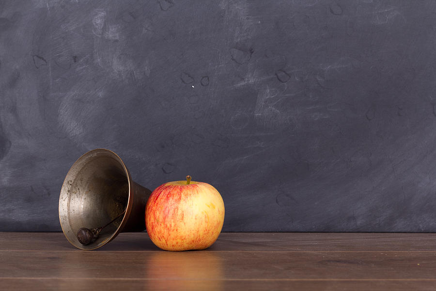 Old fashioned bell and apple against a blackboard Photograph by Christopherhall