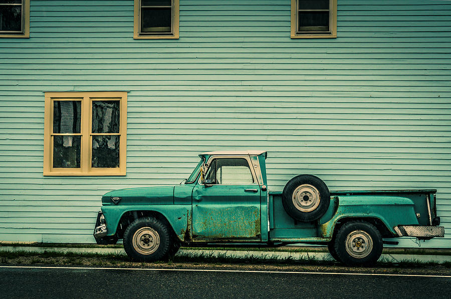 Old Green Truck against Green Building Photograph by Marcia Straub