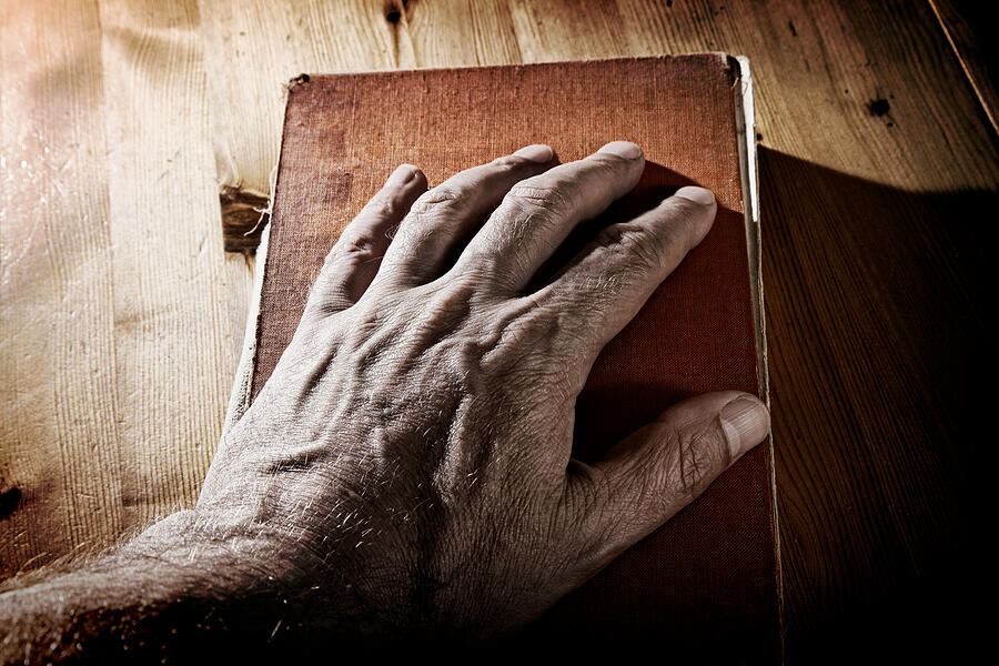 Old Hand on Book Photograph by Michael1959