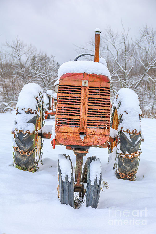 Old International Harvester Tractor in the Snow Photograph by Edward Fielding