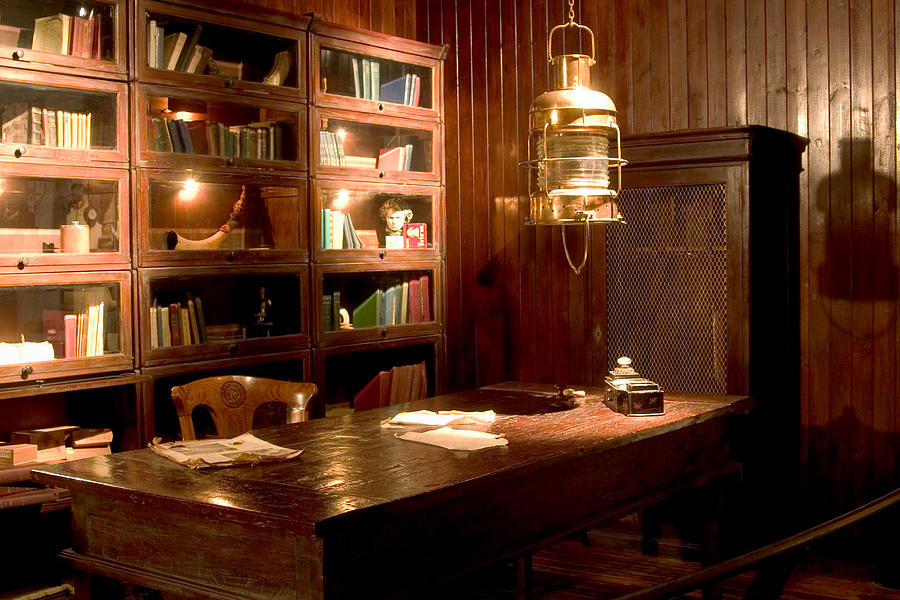 Old library setting with desk and lantern Photograph by Desperado