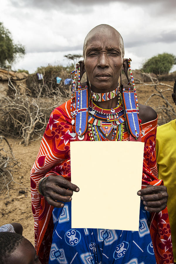 Old maasai woman with an empty paper as copuspace Photograph by Brittak