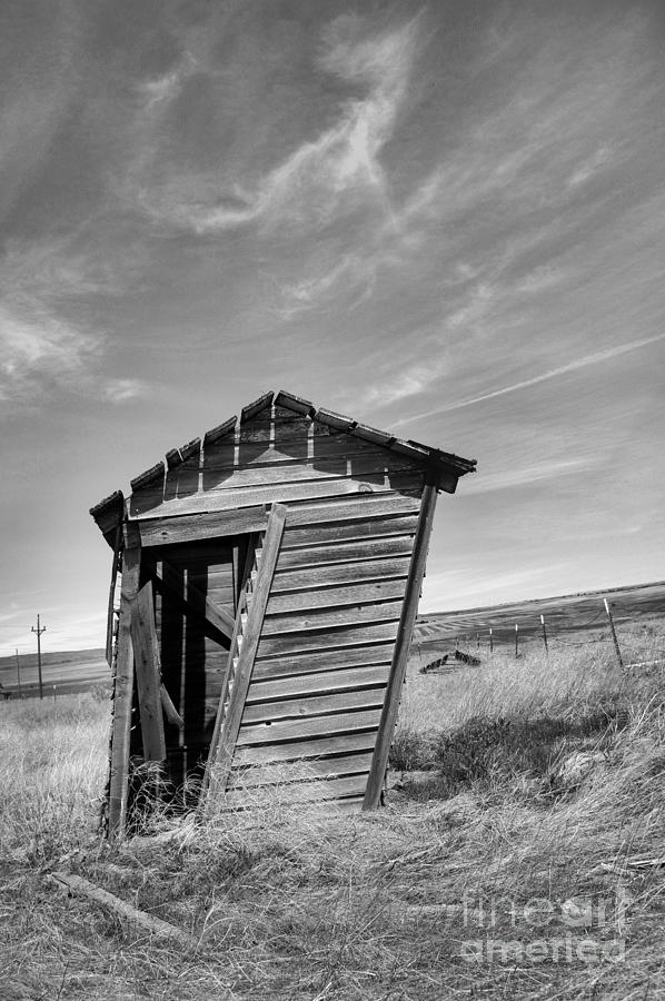 Old outhouse in black and white Photograph by Jeff Swan
