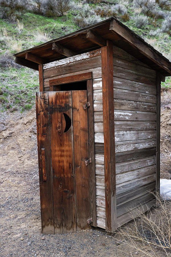 Old outhouse with the door open Photograph by Jeff Swan