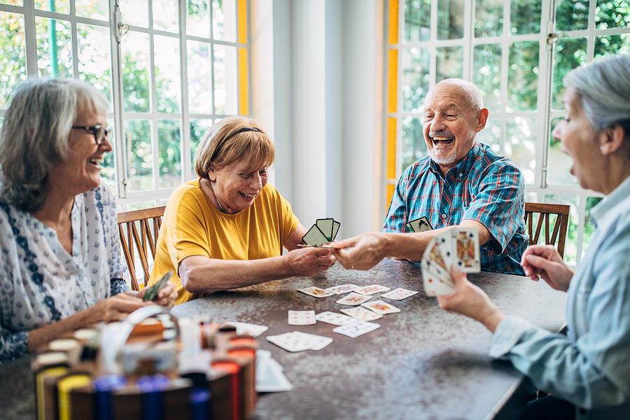 Old people having fun playing cards in nursing home Photograph by South_agency