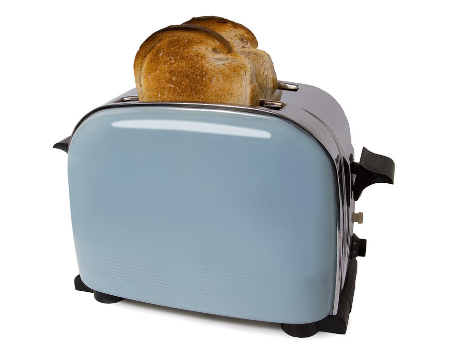 Old retro toaster with toast in on white with path Photograph by Jallfree