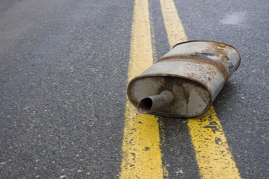 Old rusted muffler laying in the center of the road Photograph by Jamievanbuskirk