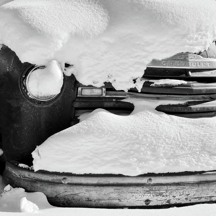 Old Rusty Chevrolet Covered By Snow In Montana Black and White Photograph by Tatiana Travelways