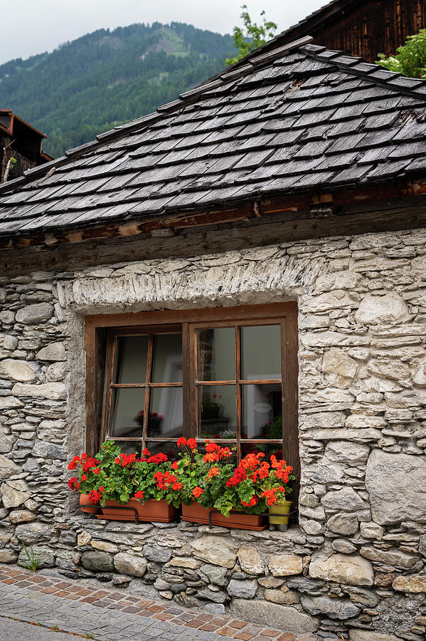 Old Stone House With Red Flowers In Matrei In Osttirol Photograph