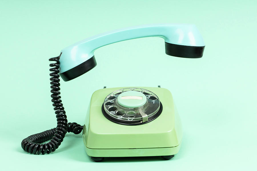 Old Telephone On Green Background. Vintage Phone With Taken Off Receiver Photograph
