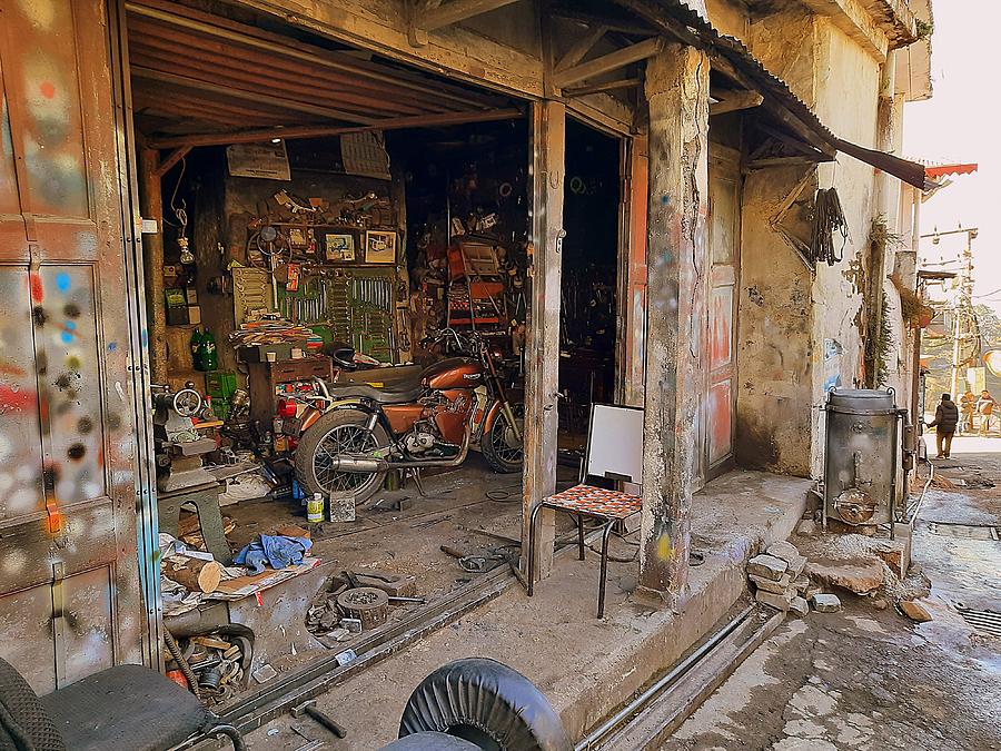 Old Triumph Bike in repair shop Photograph by Salman Ravish